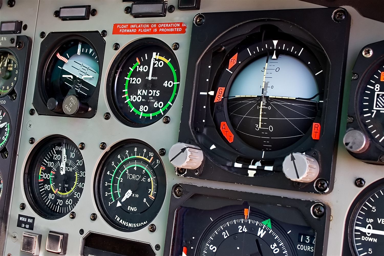 A cockpit instrument panel, airspeed and attitude indicators in view